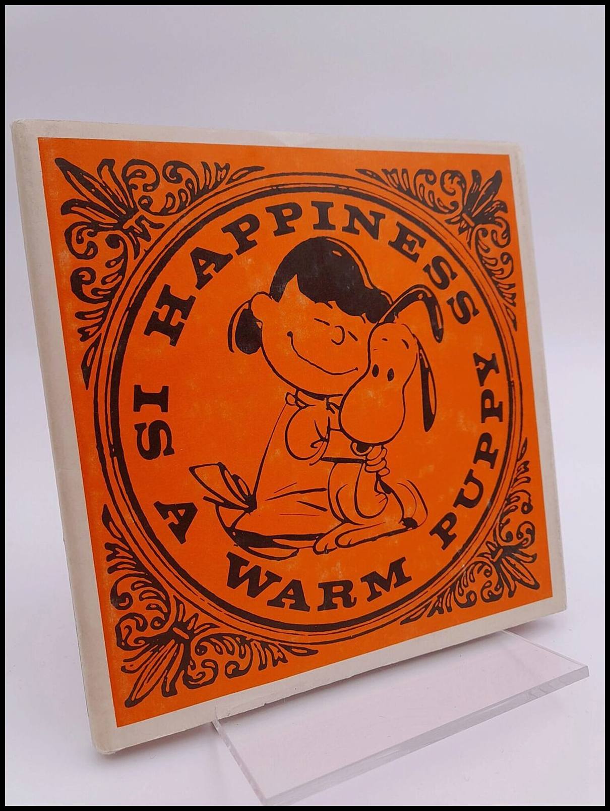 Charles M Schulz : Happiness is a Warm Puppy