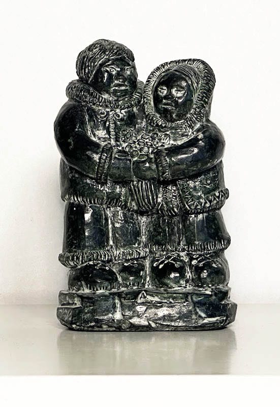 [Grönland ; Skulptur] : SKULPTUR, täljsten, inuitpar med blombukett. Formgjuten i ett täljstensliknande (soapstone) material (turistsouvenir från andra hälften av 1900-talet)